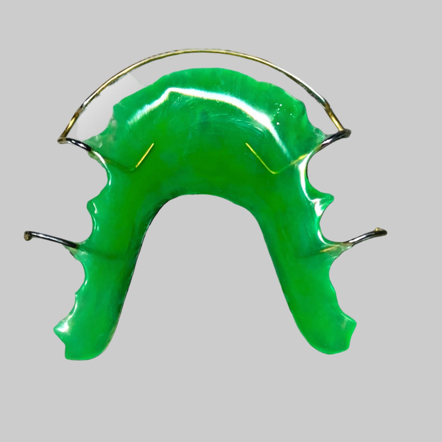 Green retainer with metal wires.